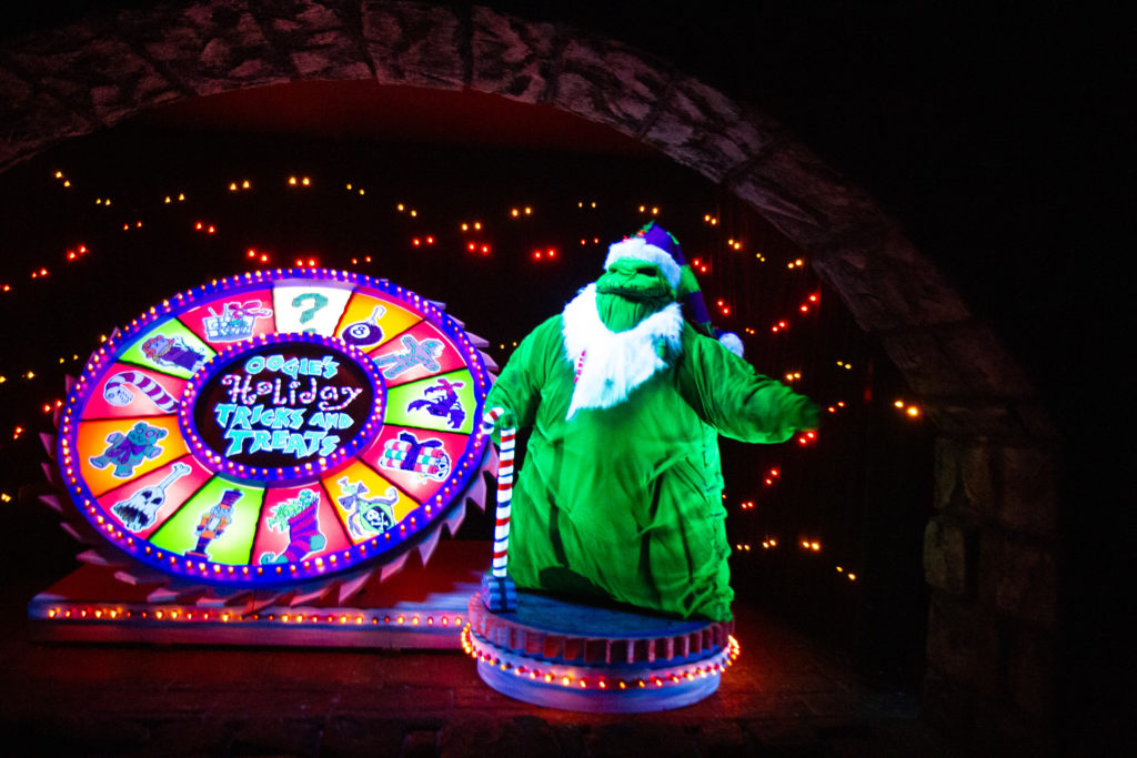 Oogie Boogie stands next to a prize wheel in the seasonal overlay to Disneyland